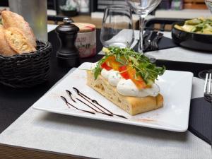 a white plate with a sandwich on a table at ibis Nîmes Ouest - A9 in Nîmes