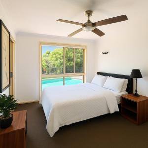 Ένα ή περισσότερα κρεβάτια σε δωμάτιο στο Banora Point Family Retreat, Pool and Nature Reserve +49 φωτογραφίες