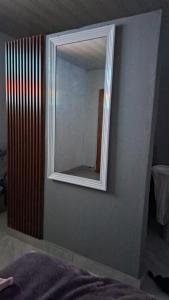 espejo en la pared de un dormitorio en DREAMS INN guest house, en Maun