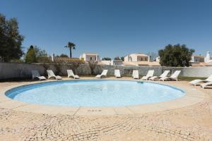 a swimming pool with lounge chairs and a swimming pool at Aldeia do Golfe - Private condominium by HD in Vilamoura