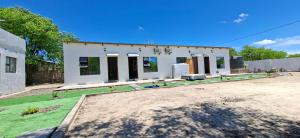 una casa que está sentada en la tierra en DREAMS INN guest house, en Maun