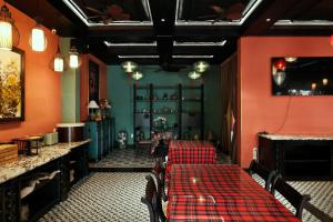 un restaurante con 2 mesas y paredes rojas en Indochine Hotel Hoi An, en An Bàn (2)