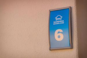 a sign on a wall with the number six at Tortolì Old Town in Tortolì