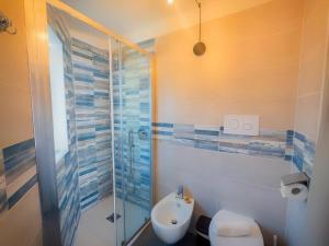 a bathroom with a shower and a toilet and a sink at Tortolì Old Town in Tortolì