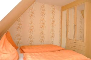 1 Schlafzimmer mit 2 Einzelbetten und einem Schrank in der Unterkunft Ferienwohnung Neubert in Wolkenstein