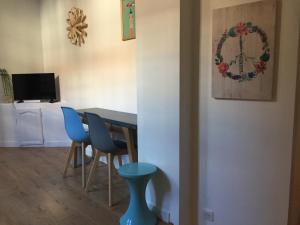 a dining room with a table and blue chairs at Lilloise Home in Lille