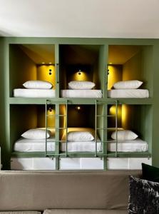 a room with a room with four bunk beds at Pink Mango Hostel in Athens