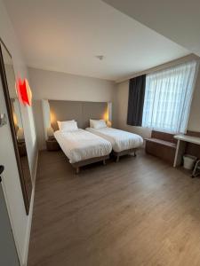 Ένα ή περισσότερα κρεβάτια σε δωμάτιο στο Campanile Annemasse Gare– Genève