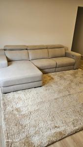 a white couch in a living room with a rug at Cosy Home in Melton South in Melton South