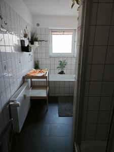 a bathroom with a tub and a sink and a bath tub at Leineblick in Seelze +22 photos