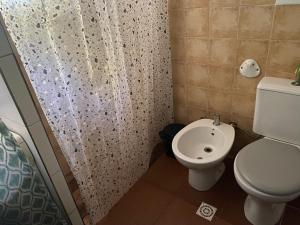 Un baño con inodoro y cortina de ducha en Alquiler en Piriapolis, en Piriápolis