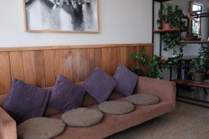 a couch with pillows sitting in a living room at apart-hotel alessia in Santiago