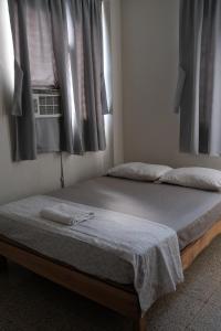 a bedroom with two beds and a window at apart-hotel alessia in Santiago