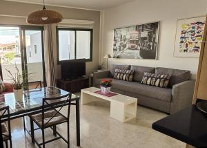 a living room with a couch and a table at Departamento Corriquia in Playa Blanca +9 photos