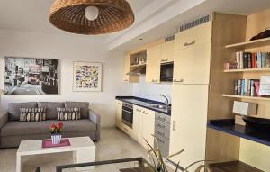 a small living room with a couch and a kitchen at Departamento Corriquia in Playa Blanca