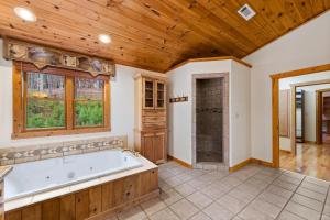 een grote badkamer met een bad en een douche bij The Bears & Bees Lodge in Greens Mill +56 foto's