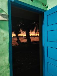 an open door with a view of the beach at Lakecampers for foreign travellers in Alleppey