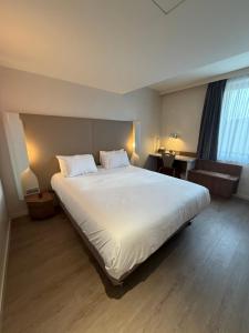 Ένα ή περισσότερα κρεβάτια σε δωμάτιο στο Campanile Annemasse Gare– Genève +55 φωτογραφίες