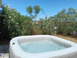 a hot tub in a yard with bushes at La Principessa Nera B&B in Ostra +68 photos