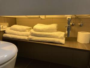 a pile of towels sitting on a counter in a bathroom at Moxy Glasgow Merchant City in Glasgow