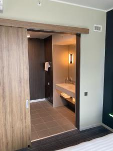 a bathroom with a sink and a mirror at Moxy Glasgow Merchant City in Glasgow +57 photos