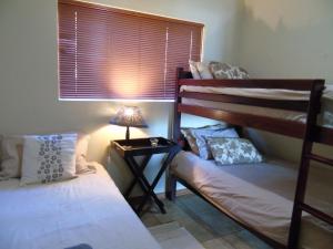 Voodi või voodid majutusasutuse Da Gama Lake Cottages - Coral Tree toas