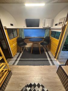 a dining room in an rv with a table and two chairs at Pousada Sitio Barreirinha in Engenheiro Passos