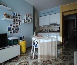 eine Küche mit Theke und Tisch in einem Raum in der Unterkunft La Casa in riva al Mare in Roccalumera