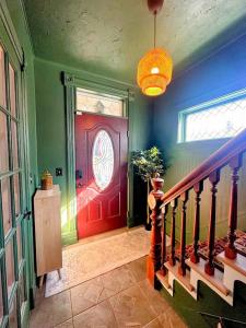 a red door with a clock on it in a room at The Hamilton Harbor House in Oswego