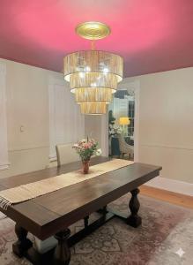 a dining room with a table and a chandelier at The Hamilton Harbor House in Oswego +24 photos