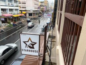 a sign for a star warehouse on a city street at Starhouse in Hat Yai +16 photos