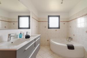 a white bathroom with a tub and a sink at La Gravière in Fontenay-Trésigny +69 photos