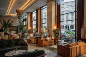 a lobby with couches and tables and large windows at Radisson Blu Hotel Casablanca City Center in Casablanca