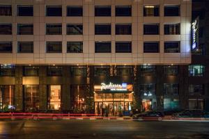 a building at night with cars parked in front of it at Radisson Blu Hotel Casablanca City Center in Casablanca