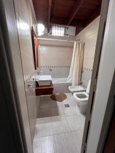 ein Badezimmer mit Waschbecken und Toilette in der Unterkunft Hermoso Chalet 6 personas a cuadras del Mar in Miramar + 11 Fotos