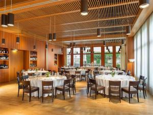 a dining room with white tables and chairs at Grand Hotel della Posta, WorldHotels Distinctive in Sondrio