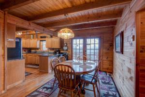 a kitchen with a table and chairs in a cabin at Atop Boone in Boone