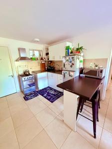 a kitchen with a refrigerator and a table in it at Hermosa habitación privada in Maldonado