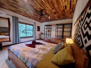 a bedroom with a bed and a large window at Villas Corcovado-AC-Jacuzzi-Pool-Great Views-Nature-Relaxing in Puerto Jiménez +125 photos
