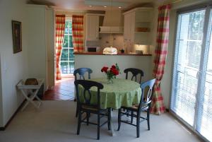 a kitchen with a table with a vase of flowers on it at Wunderschöne Wohnung In Swantow Mit Offenem Kamin in Poseritz