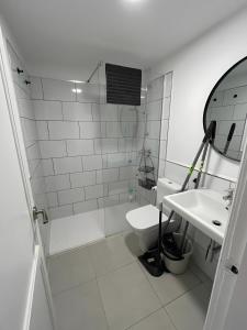 a white bathroom with a sink and a toilet at Casa Oasis in Corralejo