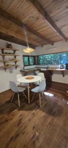 una sala da pranzo con tavolo e sedie bianchi di MONTE CABAÑA San Clemente a San Clemente Altre 8 foto