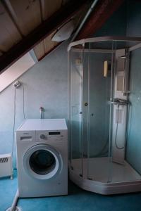 a washing machine in a room with a shower at Lødingen Brygge in Lødingen +83 photos