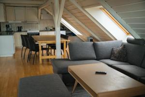 a living room with a couch and a table at Lødingen Brygge in Lødingen