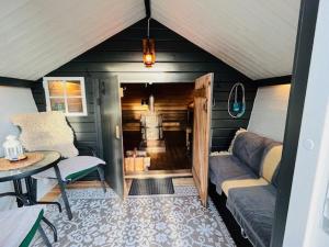 a room with a couch and a table in a house at NorrskensRo in Kiruna