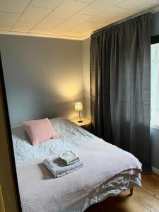 a bedroom with a bed and a window with at NorrskensRo in Kiruna +16 photos