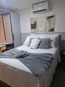 a bedroom with a large bed with two pillows at Bauten Cabo branco -Flat moderno e confortável 314 in João Pessoa