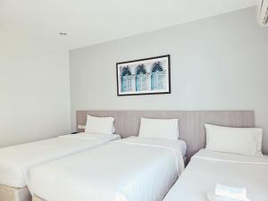 Ένα ή περισσότερα κρεβάτια σε δωμάτιο στο Recenta Phuket Suanluang by Deevana