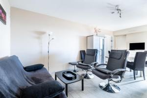 a living room with three chairs and a couch at meublé tourisme 3 étoiles vue mer in Golfe-Juan