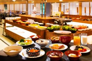 una mesa con tazones y platos de comida. en Hanare Matsushimakaku, en Aizuwakamatsu